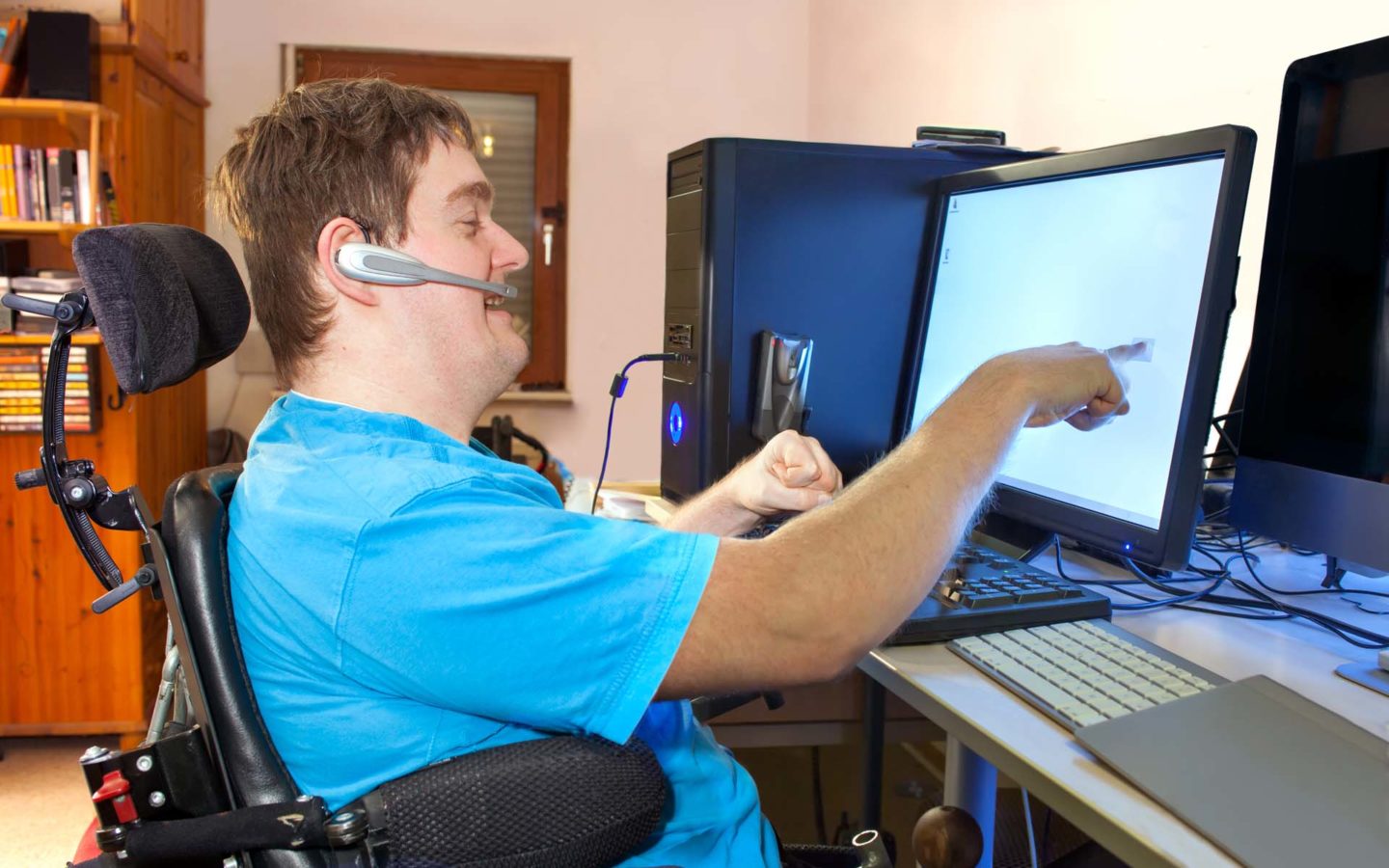 Young person with cerebral palsy using a computer