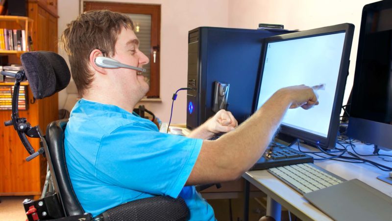 Young person with cerebral palsy using a computer
