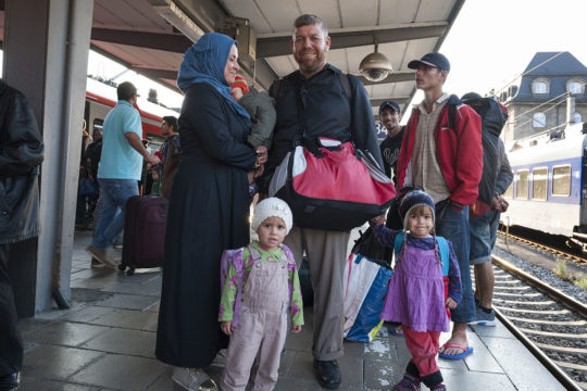 Family of refugees waiting for a train