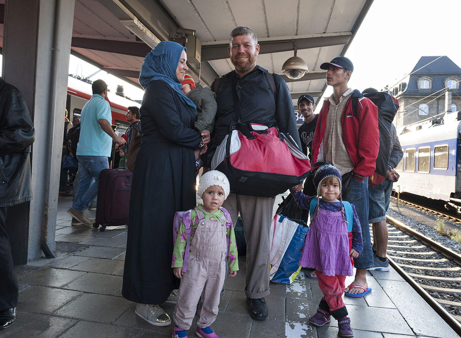 Family of refugees waiting for a train
