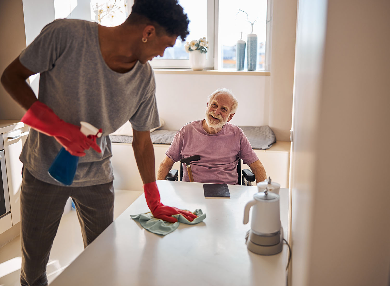 Care worker cleaning speaking with client