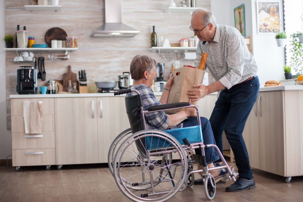 Elderly man helping woman with shopping