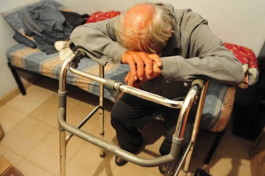 Elderly man sitting alone