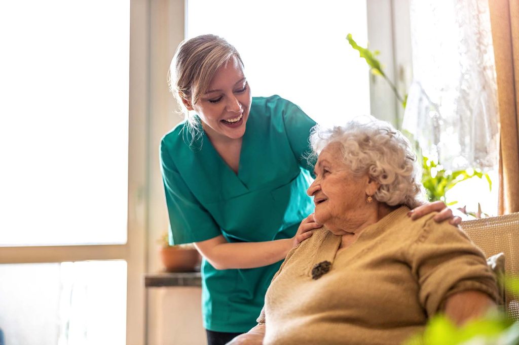 Friendly careworker supporting an elderly lady