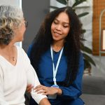 care worker providing support to elderly person