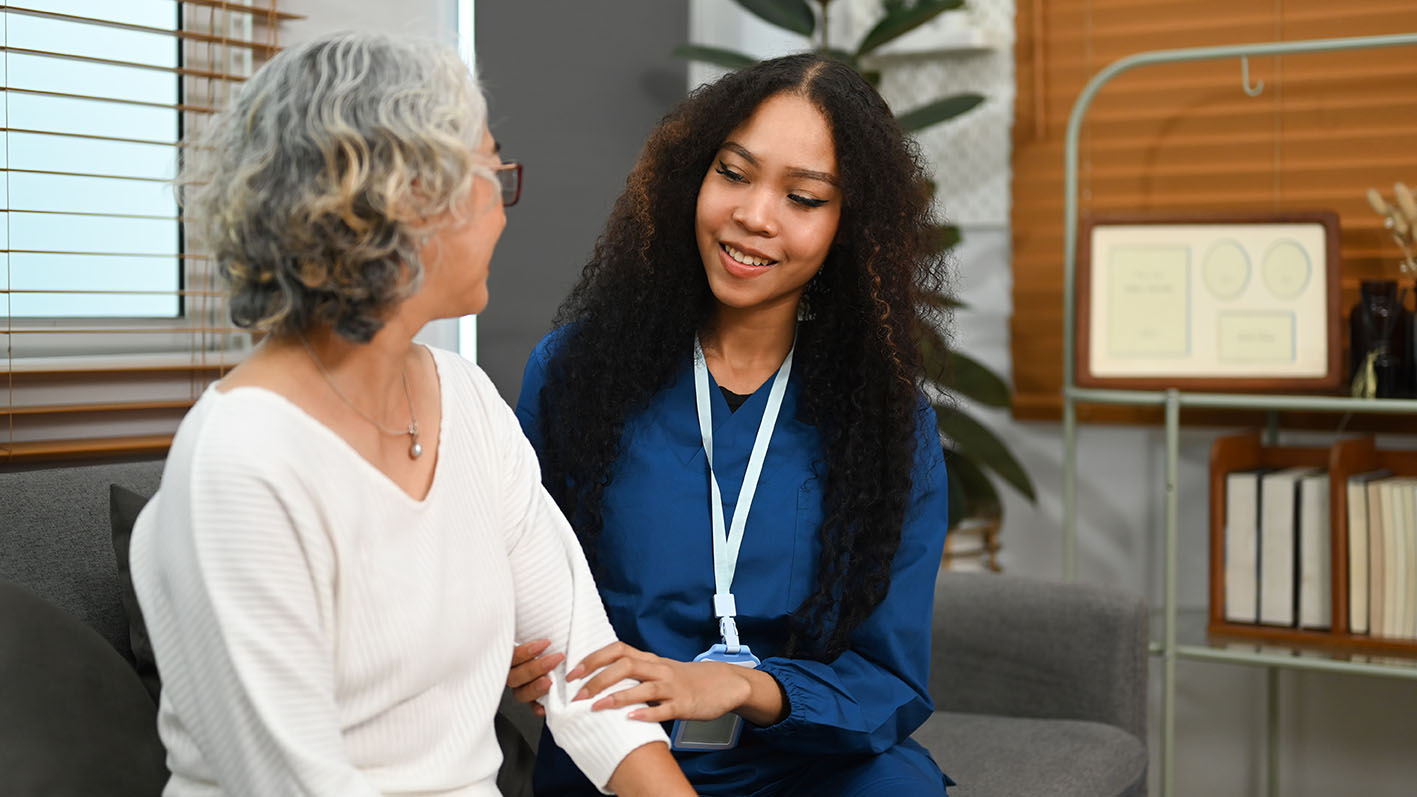 care worker providing support to elderly person