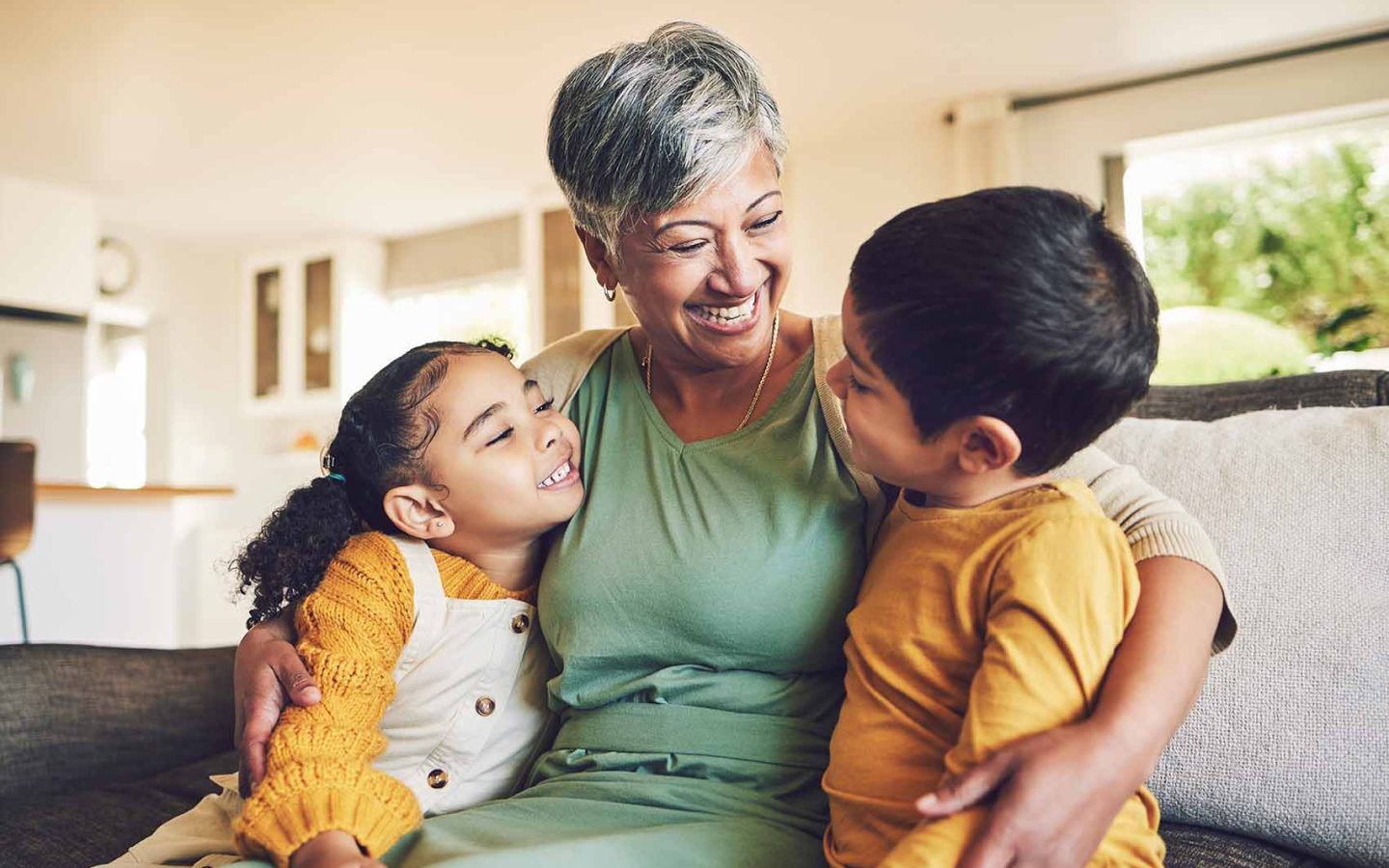 Grandparent with two children, smiling