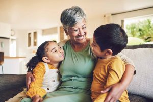 Grandparent with two children, smiling