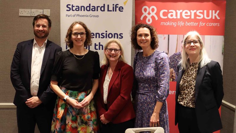 5 people in business clothes stood posing for a photo