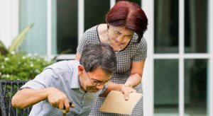 Person helping another person into a wheelchair