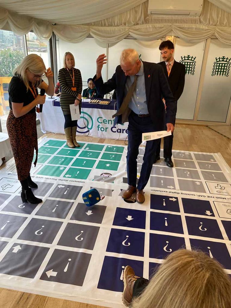 John Milne MP and others playing giant board game