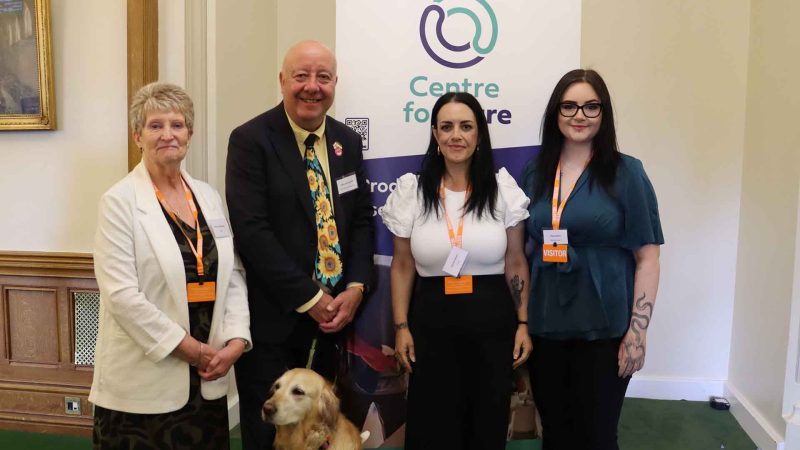 4 people posing for photo inf front of Centre for Care banner