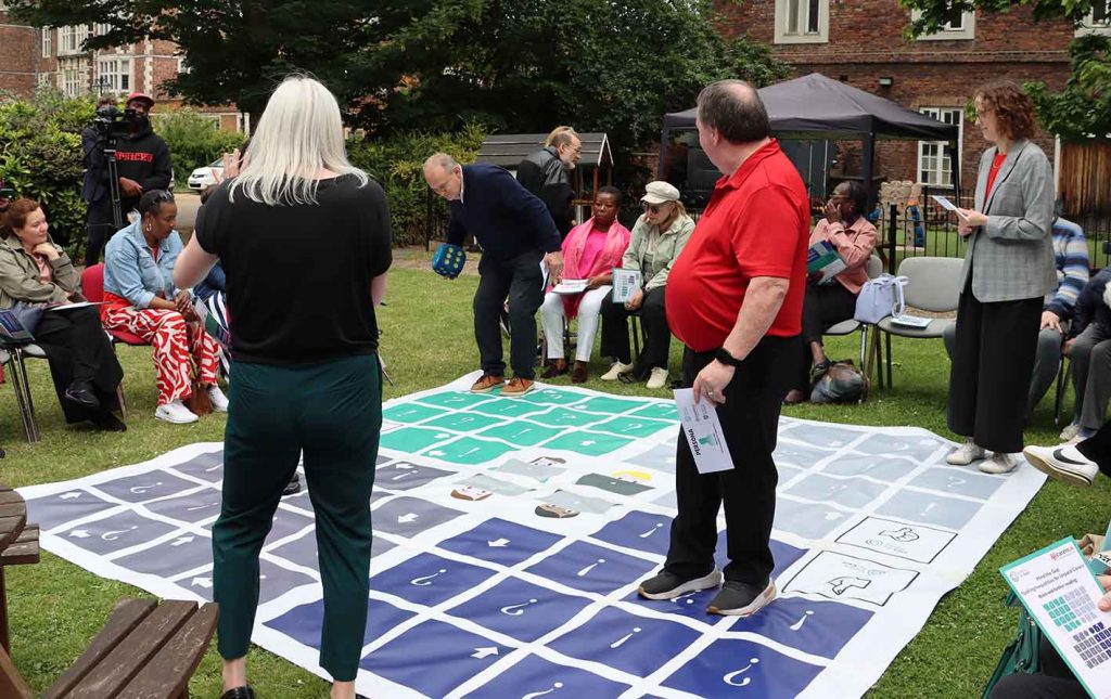 People playing giant boardgame