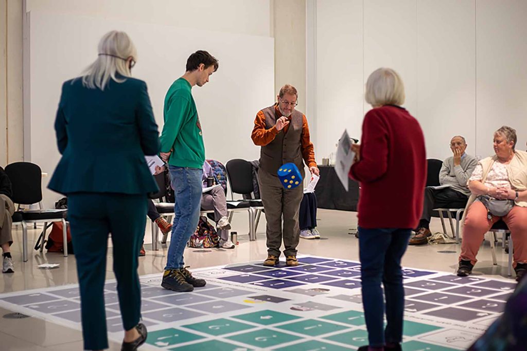 People playing giant boardgame