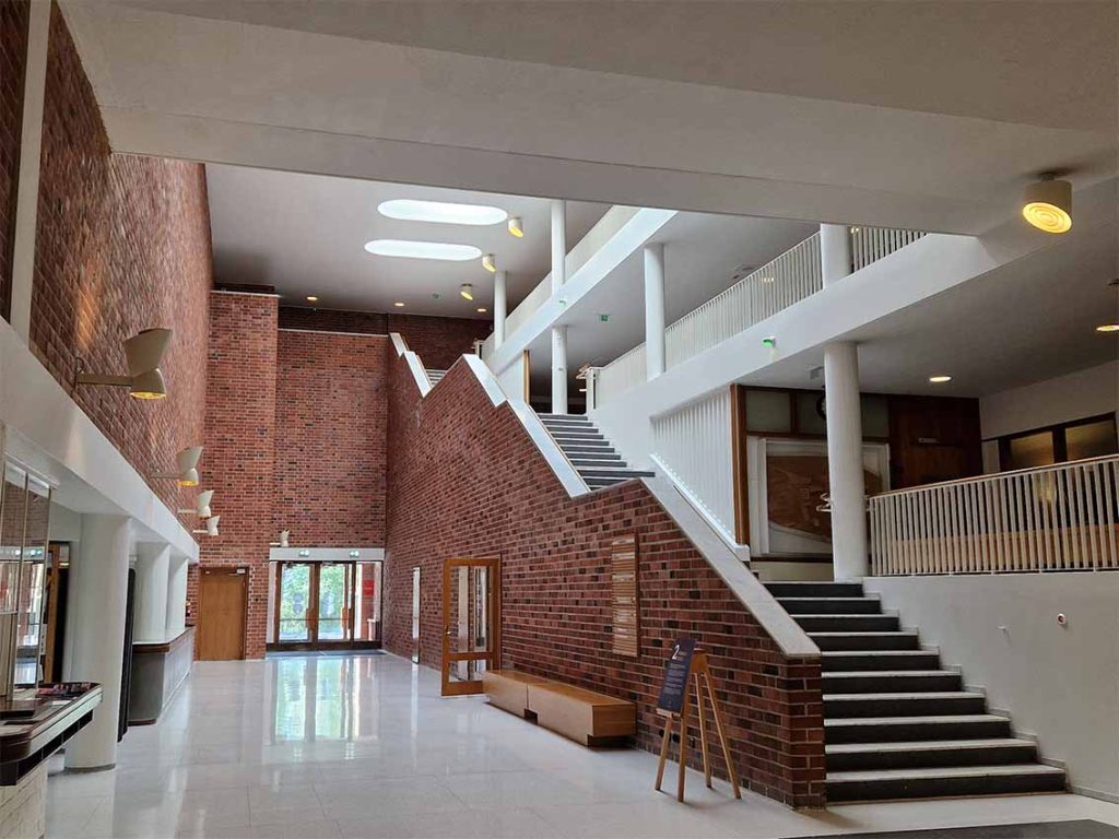 The interior of a building in The University of Jyväskylä. A staircase leads up to three seprate floors from the ground floor.