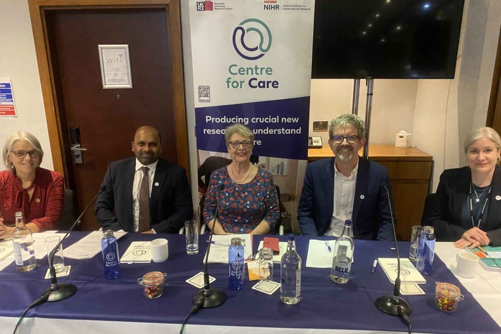 Panel members at conference smiling