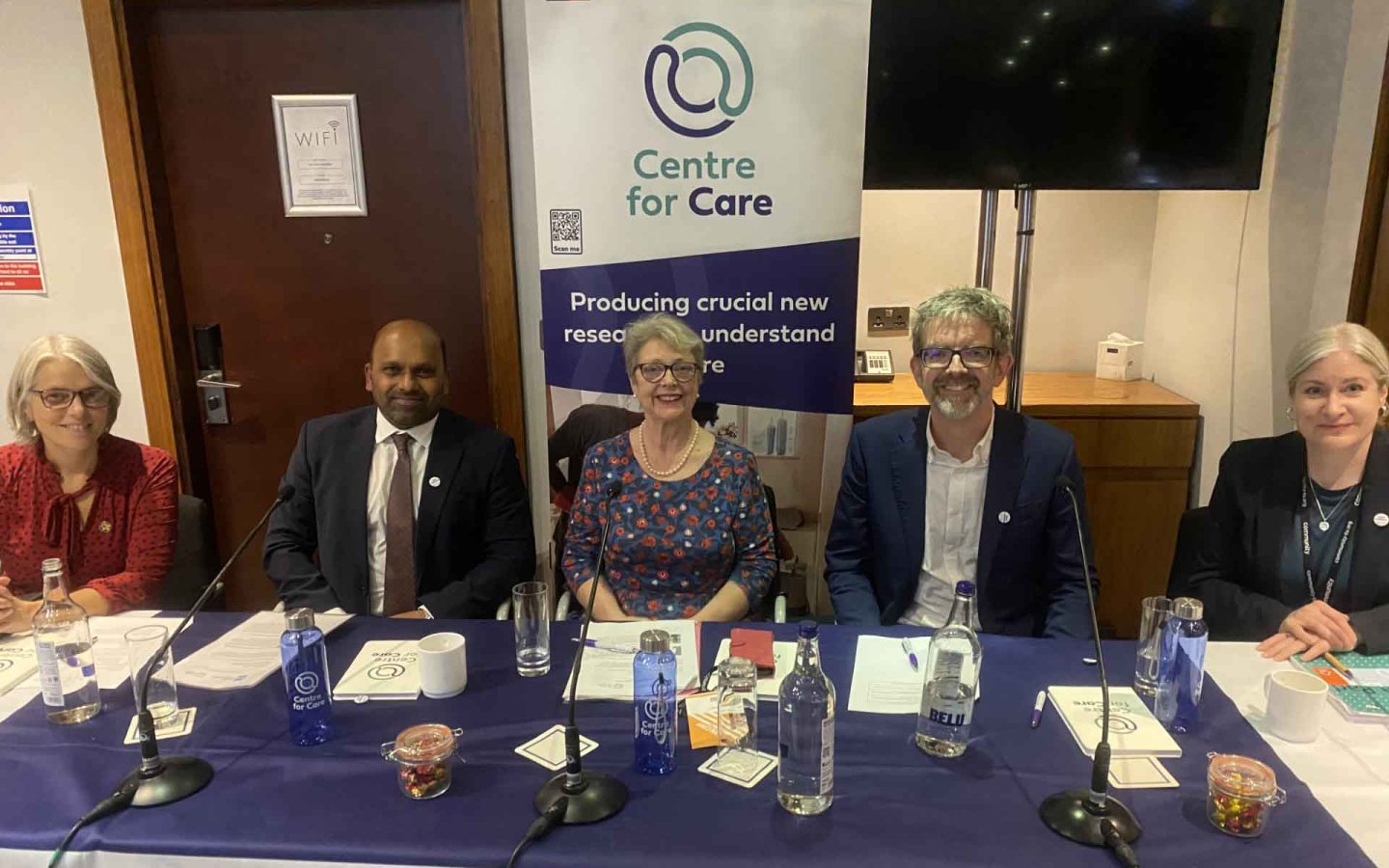 Panel members at conference smiling