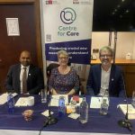 Panel members at conference smiling