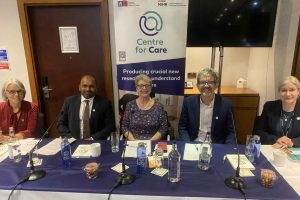 Panel members at conference smiling